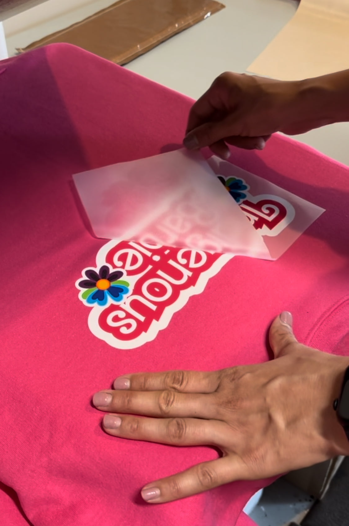 direct-to-film transfer process on a pink shirt